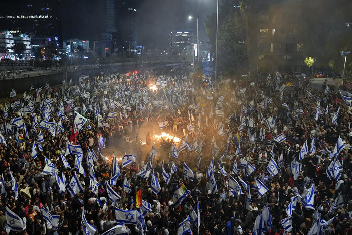 Israelis opposed to Prime Minister Benjamin Netanyahu's judicial overhaul plan set up bonfires and block a highway during a protest moments after the Israeli leader fired his defense minister, in Tel Aviv, Israel, Sunday, March 26, 2023.