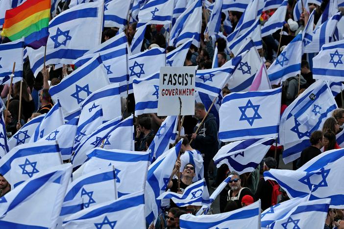 Protesters wave Israeli flags outside parliament in Jerusalem on Monday, part of a massive show of anger over the hard-right government's push to overhaul the justice system.