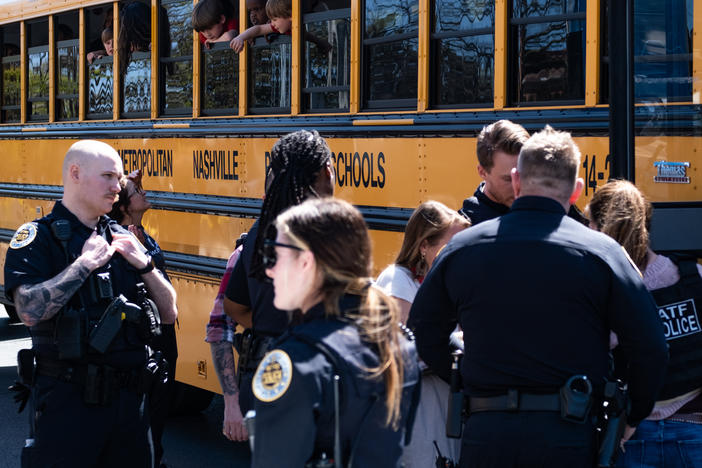 School buses with children arrive at Woodmont Baptist Church to be reunited with their families after a mass shooting at The Covenant School on Monday in Nashville.