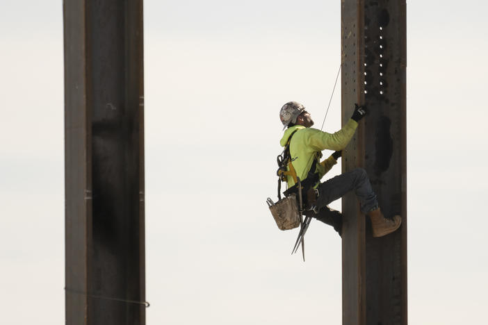 An ironworker scales a column during construction of a municipal building in Norristown, Pa. on Feb. 15, 2023.