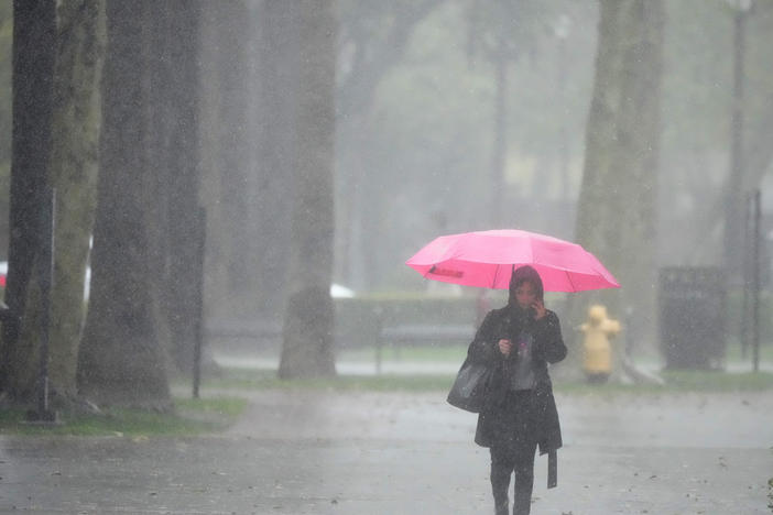 Rain falls on a pedestrian on the University of Southern California campus on Tuesday, March 21, 2023, in Los Angeles.