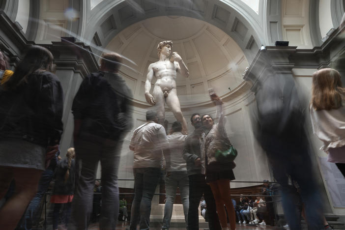 Tourists take photos in front of Michelangelo's David in the Accademia Gallery in Florence, Italy, on Tuesday. The Florence museum and the city's mayor are inviting parents and students from the Florida charter school to visit and see Michelangelo's sculpture in person.
