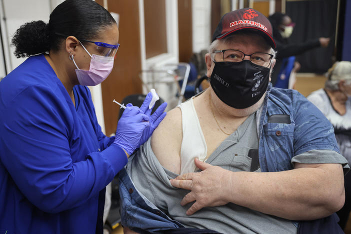 Shana Alesi administers a COVID-19 booster vaccine to Marine Corps veteran Bill Fatz at the Edward Hines Jr. VA Hospital in Hines, Ill., in 2021. A new round of boosters could become available for some people this spring.