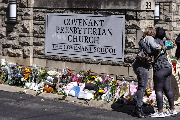 People hug at a memorial at the entrance to the Covenant School on Wednesday in Nashville, Tenn.