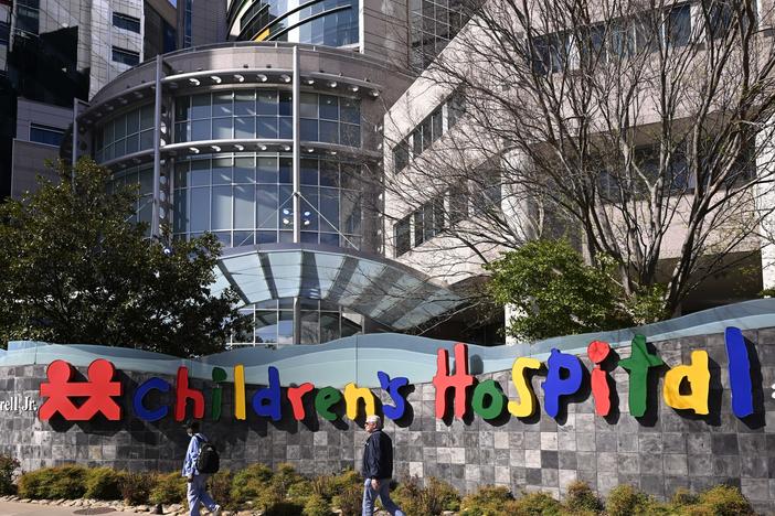 People walk past the Monroe Carell Jr. Children's Hospital at Vanderbilt, in Nashville, Tenn., on Monday, where victims were taken after a shooting at the Covenant School.