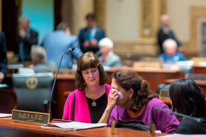 Kentucky state Sen. Karen Berg, who lost her transgender son to suicide in 2022, is consoled by former state legislator Patti Minter, left, and Rep. Tina Bojanowski after SB 150 passed the Senate on Feb. 16, 2023, in Frankfort, Ky.