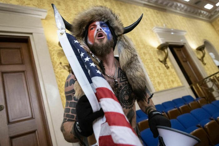 Jacob Chansley, also known as the "QAnon Shaman," screams "freedom" inside the U.S. Senate chamber after the U.S. Capitol was breached by a mob during a joint session of Congress on January 6, 2021, in Washington, D.C.