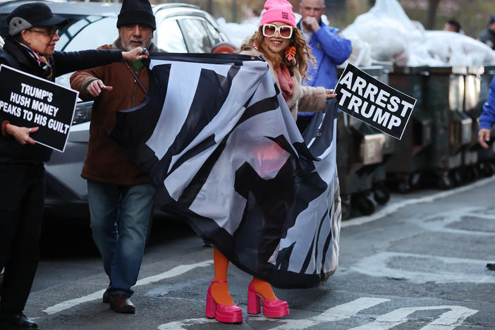 A small group of protesters gathers outside of a Manhattan courthouse after news broke that former President Donald Trump has been indicted by a grand jury on Thursday in New York City, with one pictured carrying a sign that says "arrest Trump." While the nature of the indictment is unprecedented, Trump isn't the first president — current or former — to face arrest.
