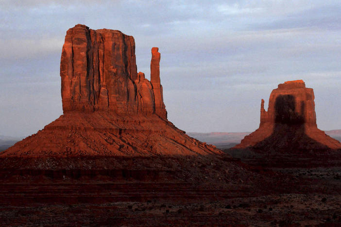 A sunset spectacle featuring two mitten-shaped rock formations crosses Monument Valley Tribal Park on Wednesday.