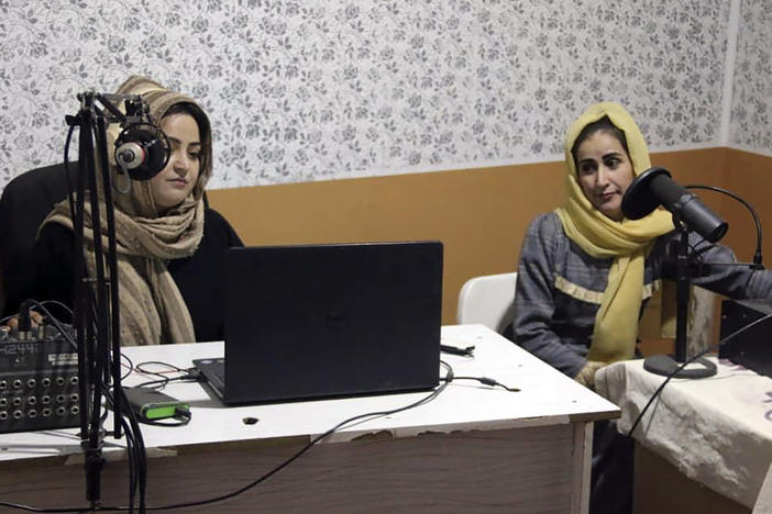 Najia Sorosh, head of Sadai Banowan a women-run radio station, left, speaks into a microphone in the studio in Badakhshan province, Afghanistan, on Jan. 4. A women-run radio station in Afghanistan's northeast has been shut down for playing music during Ramadan, a Taliban official said.