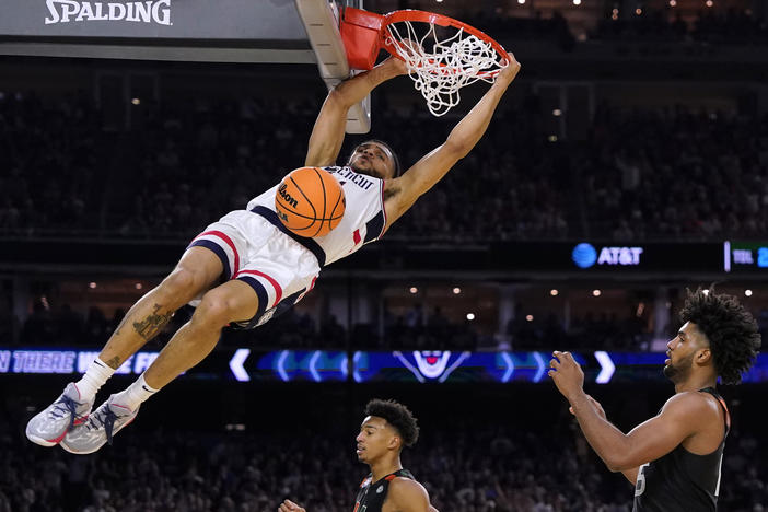 Connecticut guard Andre Jackson Jr. dunks the ball over Miami forward Norchad Omier, right, during the second half of a Final Four college basketball game in the NCAA Tournament on Saturday, April 1, 2023, in Houston.