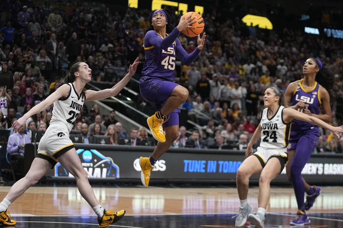LSU's Alexis Morris shoots past Iowa's Caitlin Clark during the second half of the NCAA Women's Final Four championship basketball game Sunday in Dallas.