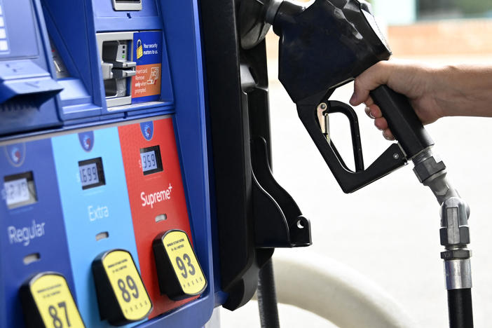 A person goes to the pump at a gas station in Arlington, Va., on July 29, 2022. Gas prices have come down significantly since peaking last year but they could rise again after Saudi Arabia and other countries said they would collectively cut oil production by more than one million barrels.