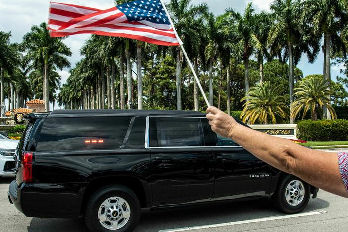 Former President Donald Trump sits in the rear of his limousine as he departs Trump International Golf Club in West Palm Beach, Florida, on Sunday.