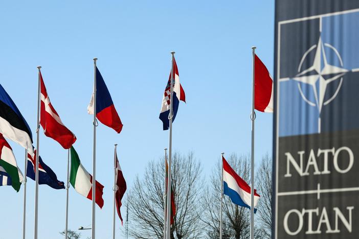 The national flags of countries in NATO fly outside the organization headquarters in Brussels on Monday. Finland's flag will be added to the group.