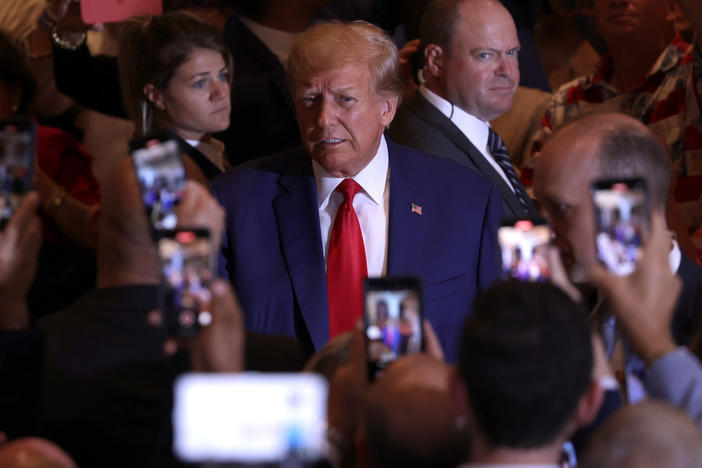 Former President Donald Trump arrives at an event Tuesday evening at his Mar-a-Lago estate in Palm Beach, Fla., after pleading not guilty in New York to 34 felony counts.