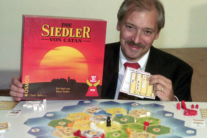 Klaus Teuber, a dental technician from Darmstadt, presents his game The Settlers of Catan on Sept. 29, 1995, in Frankfurt, Germany.