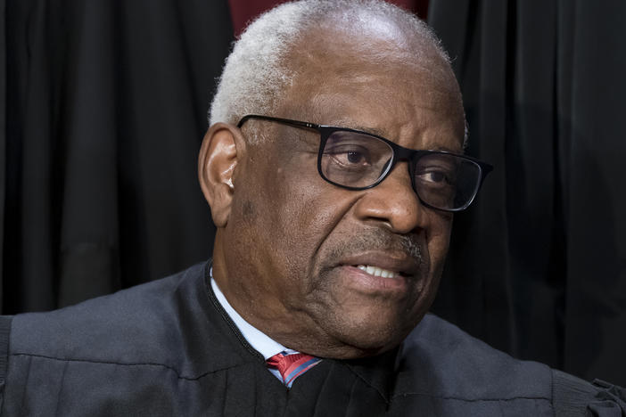 Justice Clarence Thomas joins other members of the Supreme Court as they pose for a new group portrait, at the Supreme Court building in Washington, Friday, Oct. 7, 2022.