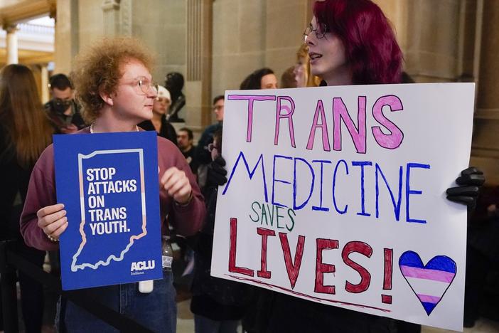 Protesters stand outside of the Senate chamber at the Indiana Statehouse on Feb. 22, 2023, in Indianapolis. Republican Governors in Indiana and Idaho have signed into law bills banning gender-affirming care for minors early April 2023, making those states the latest to prohibit transgender health care this year.