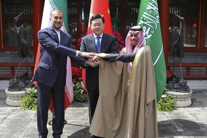 In this picture released by the Iranian Foreign Ministry, Iran's Foreign Minister Hossein Amirabdollahian, left, shakes hands with his Saudi Arabian counterpart Prince Faisal bin Farhan Al Saud, right, and Chineses counterpart Qin Gang in Beijing Thursday, April 6, 2023.