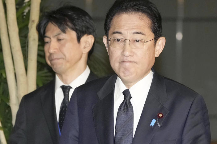 Japan's Prime Minister Fumio Kishida (right) meets with reporters in Tokyo after an army helicopter went missing on Thursday.