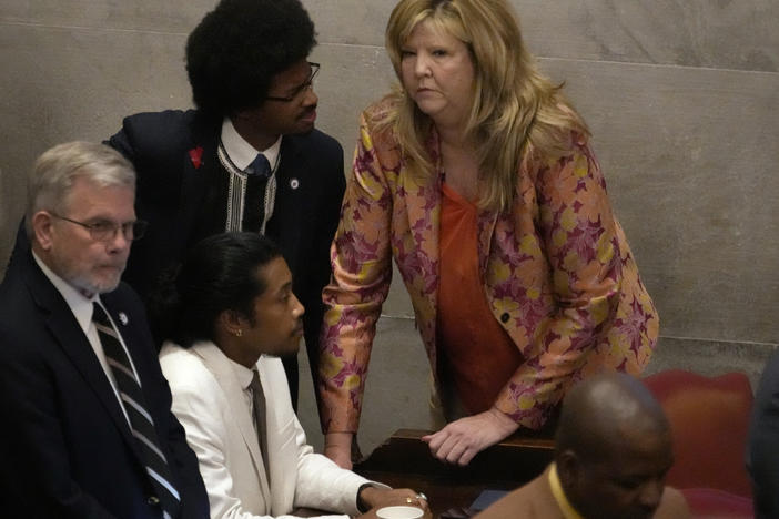 Rep. Justin Jones, D-Nashville, center, Rep. Justin Pearson, D-Memphis, back left and Rep. Gloria Johnson, D-Knoxville, huddle on the floor of the House chamber Thursday, April 6, 2023, in Nashville, Tenn.