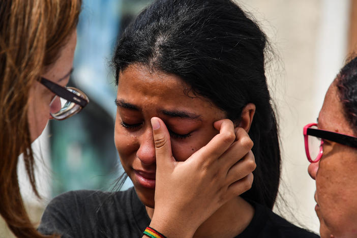 A student cries after the 2019 attack on a public school in the state of Sao Paulo, Brazil. The attack, by two former students, resulted in 10 deaths, including the attackers, who turned their weapons on themselves. It was one of the deadliest school attacks in the country's history.