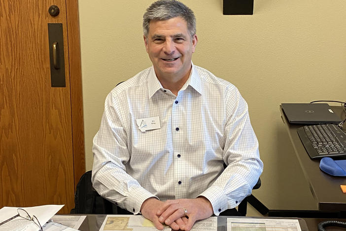 A.J. King, the CEO of Three Rivers Bank in Kalispell, Mont., sitting at his office. King says his bank shouldn't have to pay for mismanagement at Silicon Valley Bank and Signature Bank.