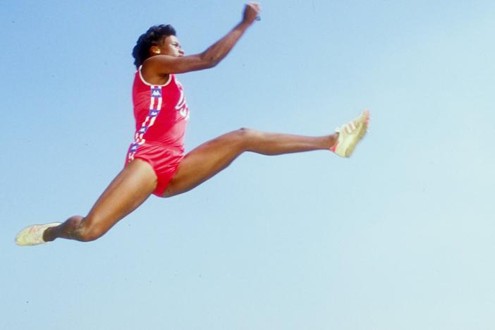 Jackie Joyner-Kersee, performing one of her famous long jumps in 1985.