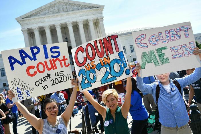Demonstrators hold signs about counting Asian Americans and Pacific Islanders in the U.S. census during a 2019 protest outside the Supreme Court in Washington, D.C., against the failed push to add a citizenship question by former President Donald Trump's administration.