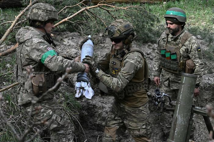 Ukrainian troops prepare to fire a mortar toward Russian positions on the frontline in the eastern region of Donetsk on Wednesday.