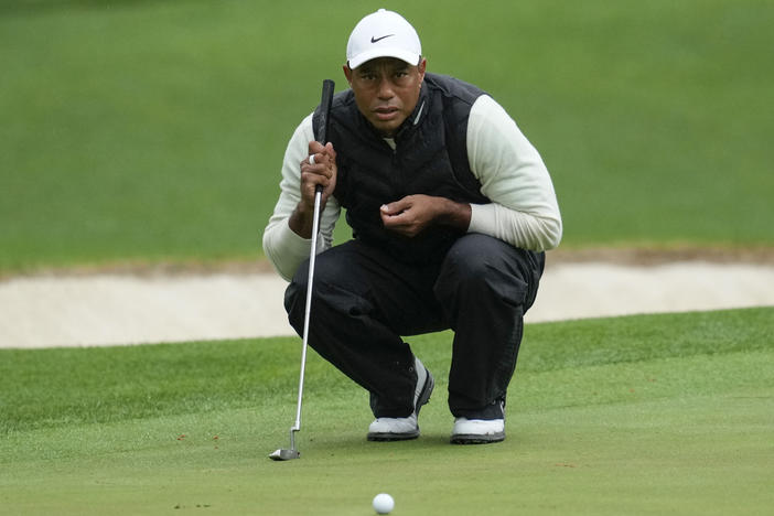 Tiger Woods lines up a putt on the 16th hole during the weather-delayed second round of the Masters golf tournament at Augusta National Golf Club on Saturday, April 8, 2023, in Augusta, Ga.