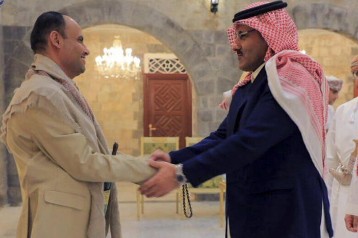 In this handout photo released on April 9, 2023 by the Houthi group's media arm Ansar Allah, head of the Houthi's supreme political council Mahdi al-Mashat, left, shakes hands with Saudi Arabia's Ambassador to Yemen Mohammed bin Saeed Al-Jaber, in Sanaa, Yemen.