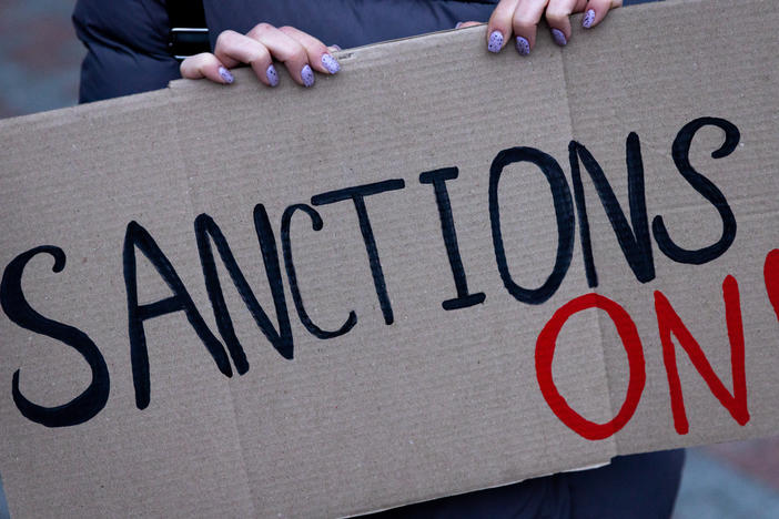 KYIV, UKRAINE - FEBRUARY 21: A group of people hold signs at the front of the Ukrainian Foreign Ministry during a protest calling for the European Union to impose additional sanctions against Russia on February 21, 2022 in Kyiv, Ukraine.