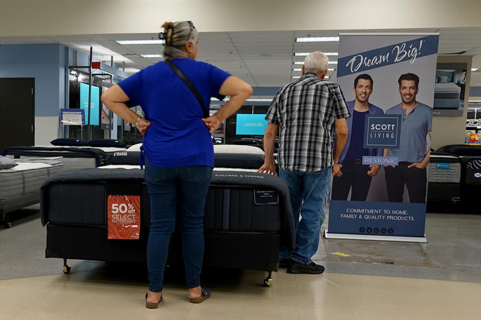 Shoppers look over mattresses at a store in Miami on March 14, 2023.