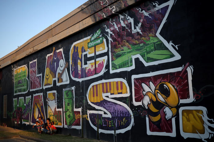 A mural marking Black Wall Street, also called the Greenwood District, in Tulsa, Okla. The Tulsa Race Massacre in 1921 devastated Black Wall Street and claimed some 300 African American lives.