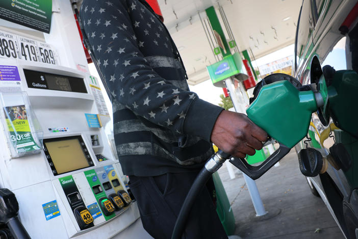 A person prepares to pump gas at a BP gas station in Brooklyn, New York City, on Oct. 19, 2022. Americans could save between $580 billion and $1.1 trillion on gasoline under the EPA's proposed auto emission regulations, according to the agency.