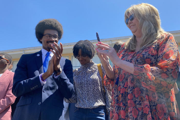 Justin J. Pearson stands with state Rep. Gloria Johnson during a rally in Memphis, Tenn., before a vote to reinstate him to the Tennessee House on Wednesday.