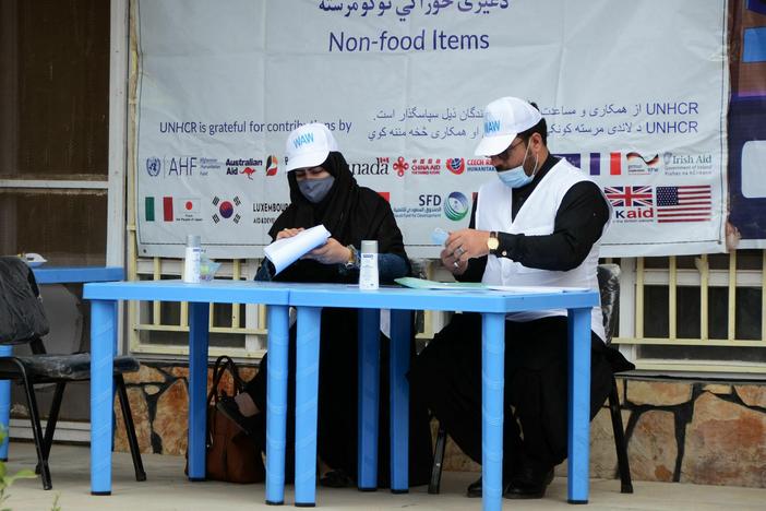 United Nations High Commissioner for Refugees workers prepare to distribute non-food items to women at UNHCR office in Kandahar on March 8, 2022. The Taliban has demanded that Afghan women no longer work for the UN or NGOs.