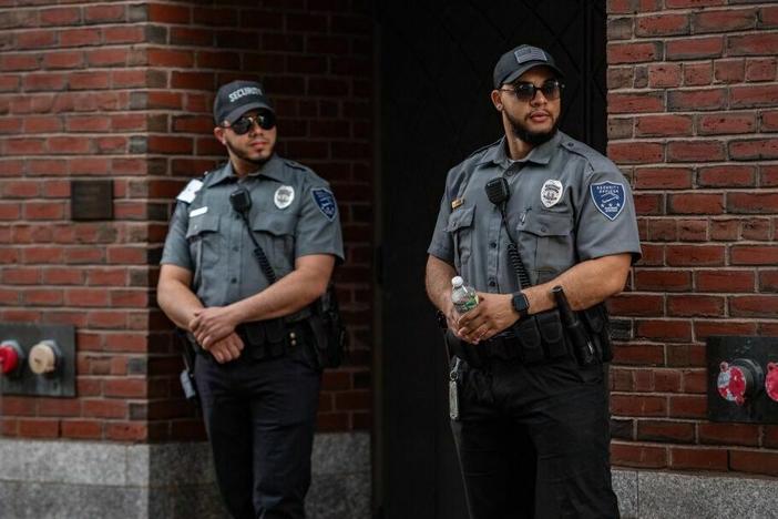 Security guards stand outside the entrance to the John Joseph Moakley United States Courthouse in Boston on Friday. Jack Teixeira, 21, an employee of the U.S. Air Force National Guard, appeared at the federal court Friday.