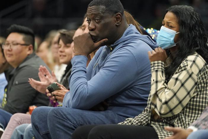 Former Seattle SuperSonics forward Shawn Kemp, center, attends a WNBA basketball game between the Seattle Storm and the Chicago Sky on May 18, 2022, in Seattle. Prosecutors in Washington state charged Kemp on Friday, April 14, 2023, with first-degree assault in a parking lot shooting last month over a stolen cell phone.