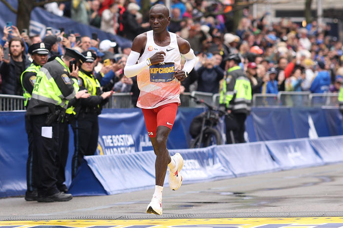 Eliud Kipchoge crosses the finish line and takes sixth place in the professional Men's Division during the 127th Boston Marathon.
