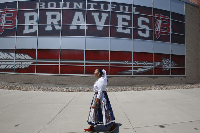 Lemiley Lane, who grew up in the Navajo Nation in Arizona, walks along the Bountiful High School campus during her junior year in 2020 in Bountiful, Utah. The school changed its nickname in 2021 to "The Redhawks."