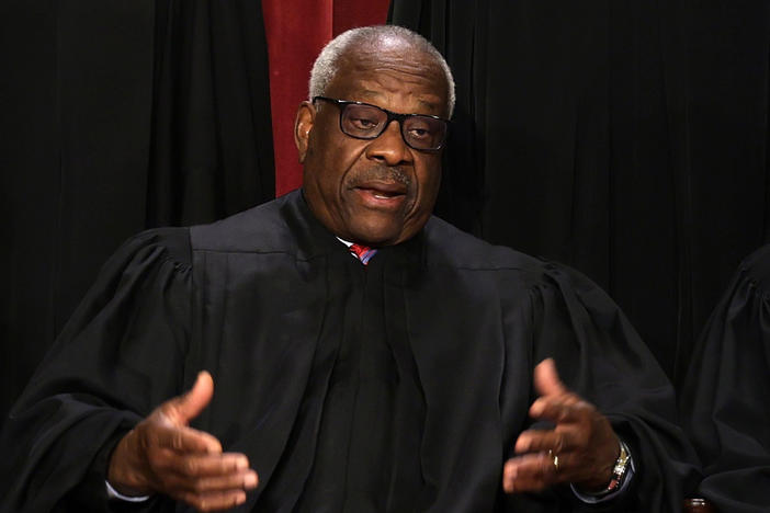 Supreme Court Justice Clarence Thomas poses with Justice Sonia Sotomayor and Chief Justice John Roberts pose for their official portrait in 2022.