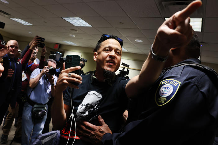 A critic of Manhattan District Attorney Alvin Bragg is led out of the room by police during a House Judiciary Committee field hearing on violent crime in New York on Monday.