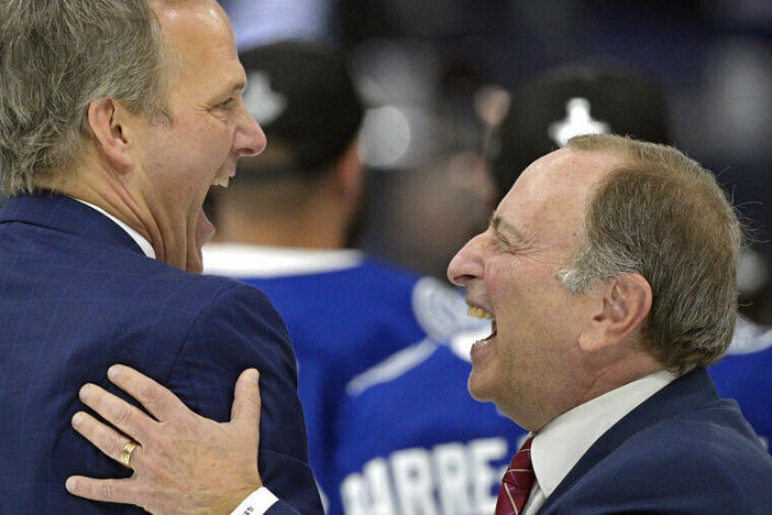 National Hockey League Commissioner Gary Bettman celebrates after Game 5 of the NHL 2021 Stanley Cup with Tampa Bay Lightning head coach Jon Cooper.