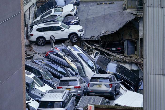 Cars are seen piled on top of each other at the scene of a partial collapse of a parking garage in the Financial District of New York, Tuesday, April 18, 2023, in New York.