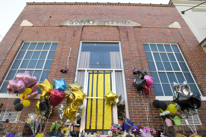 A makeshift memorial is created at the scene of the fatal shooting at a dance studio in Dadeville, Ala. Two teenagers have been arrested and charged with murder in connection with the shooting that killed four young people at a Sweet Sixteen birthday party, investigators announced Wednesday.