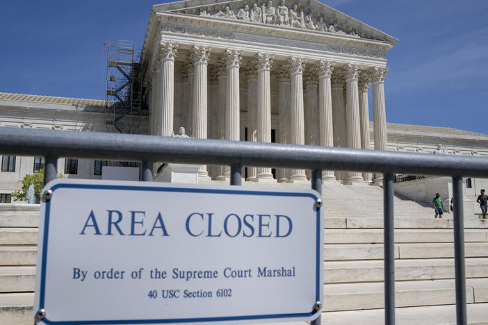 Security fencing is seen as people visit the Supreme Court on April 19.