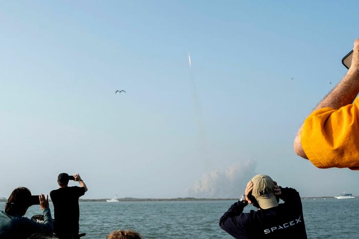 Spectators watch from South Padre Island, Texas, as the SpaceX Starship launches on Thursday. It exploded several minutes later.